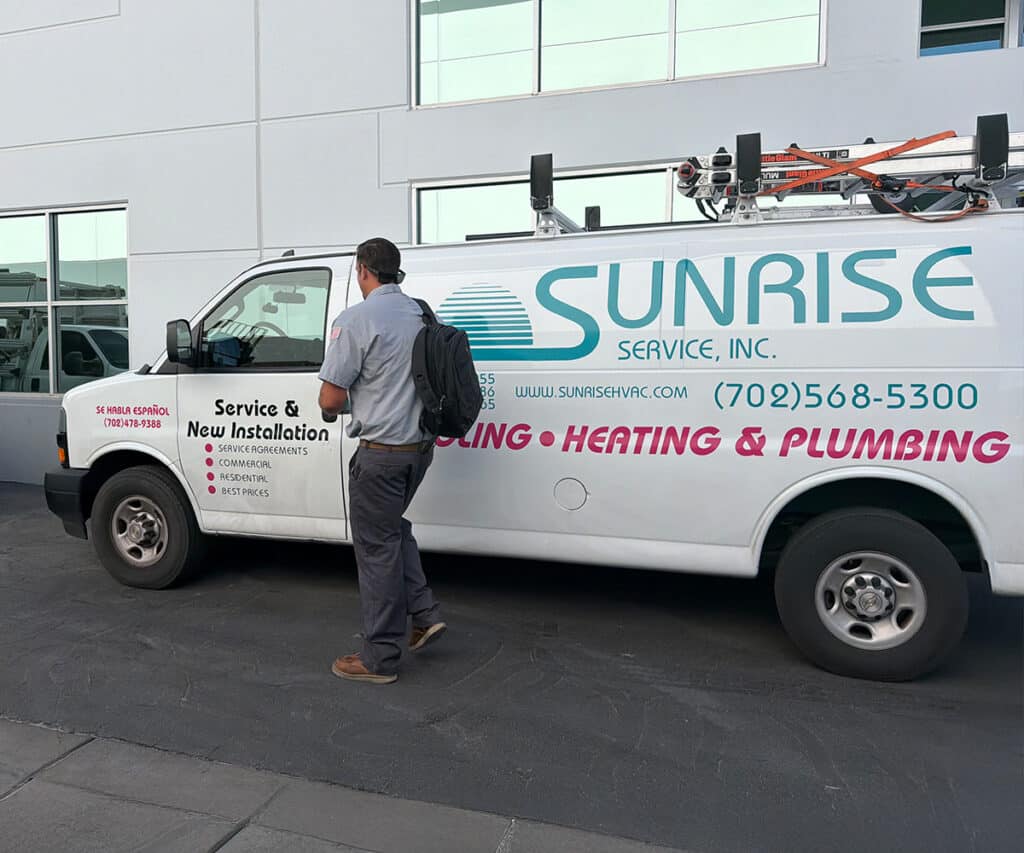 Sunrise Service technician walking toward his work van