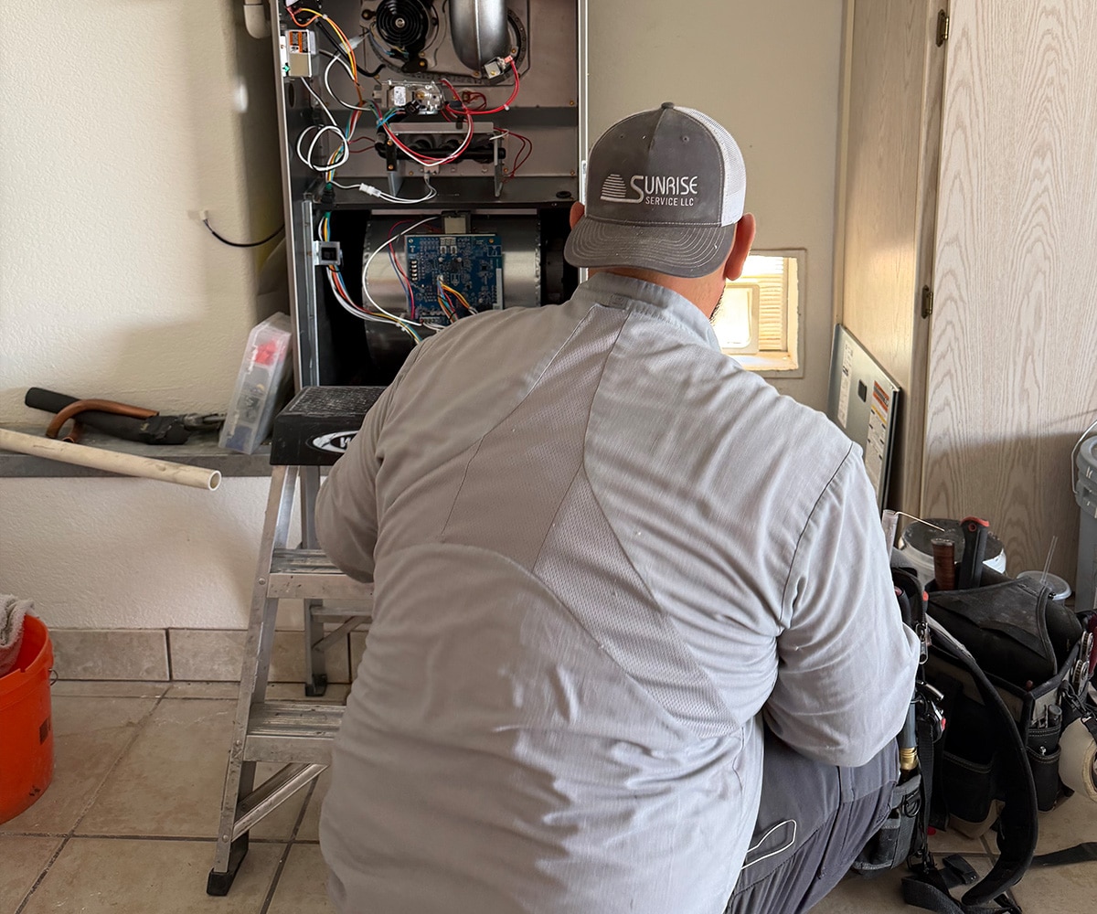 Sunrise Service technician repairing furnace