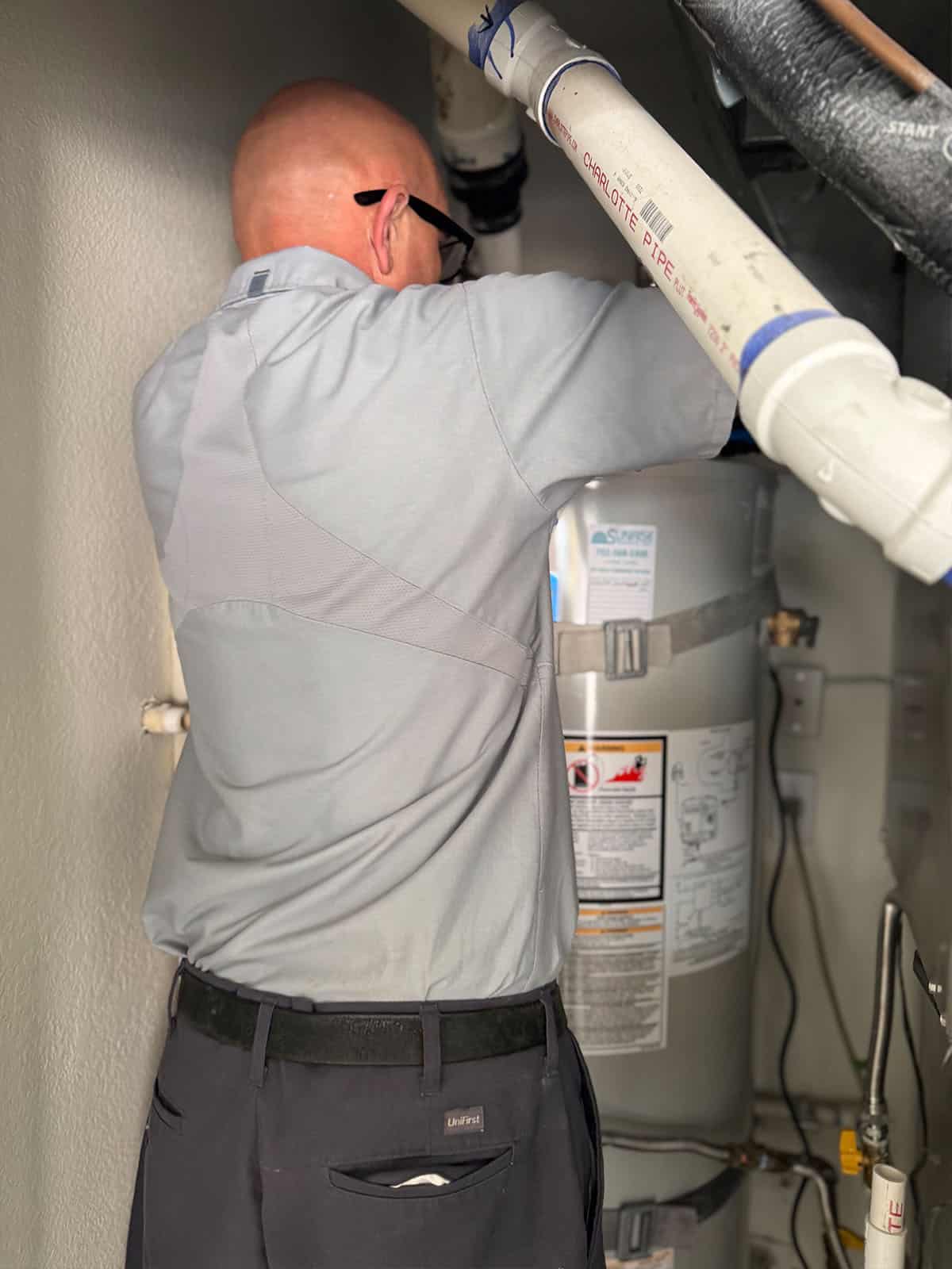 plumber fixing heat tank