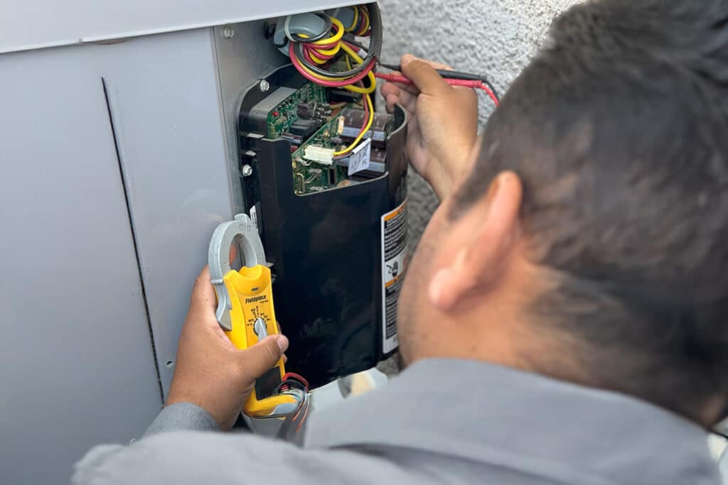 Sunrise's Technician reading an HVAC Gauge