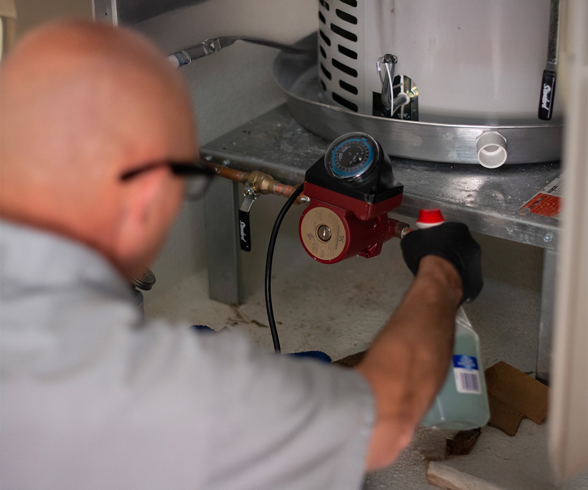 sunrise's tech cleaning under heater tank