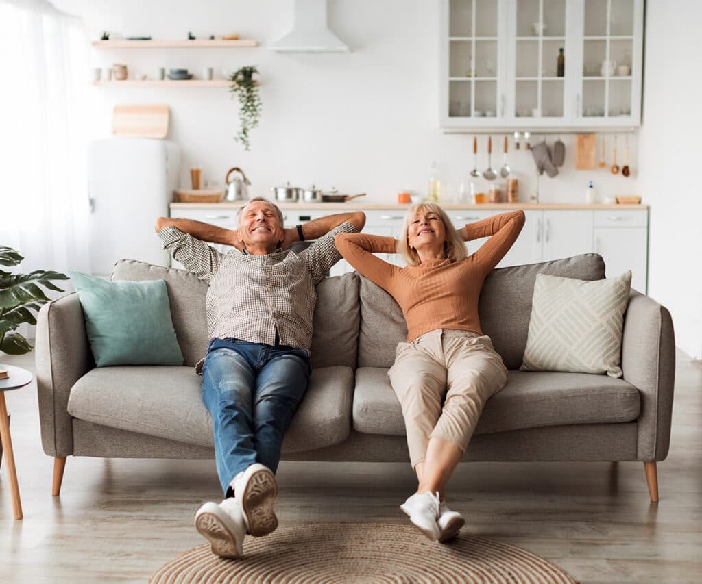 couple resting comfortably on a sofa