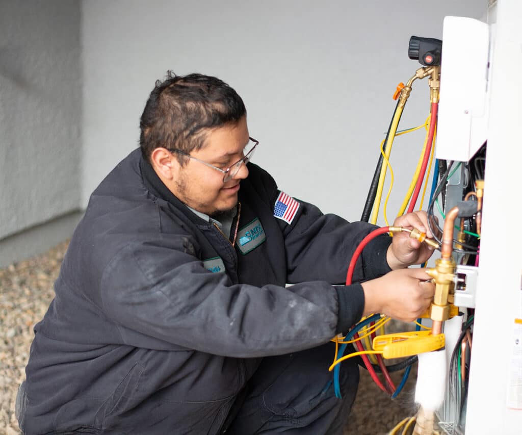 sunrise's technician installing heat pump