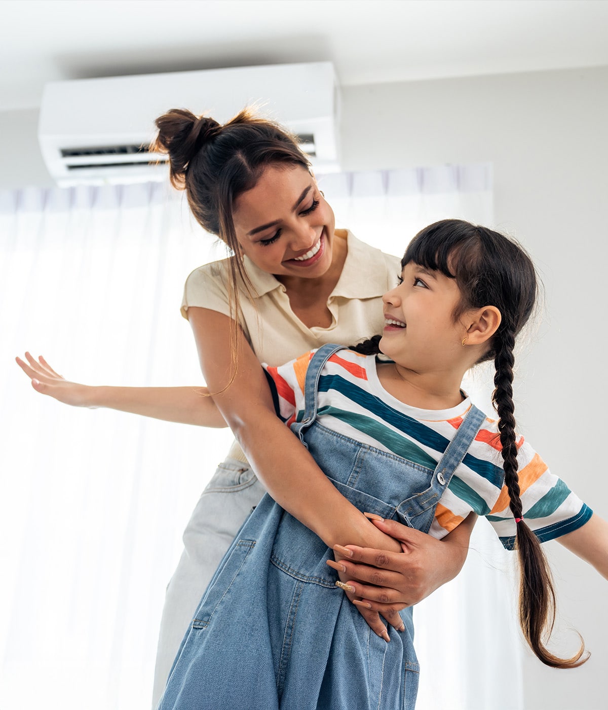 A playful interaction between a mother and her daughter