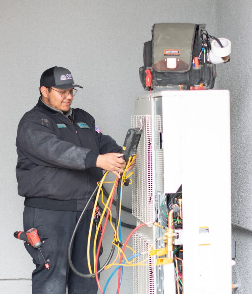 sunrise tech looking at heat pump pressure reading