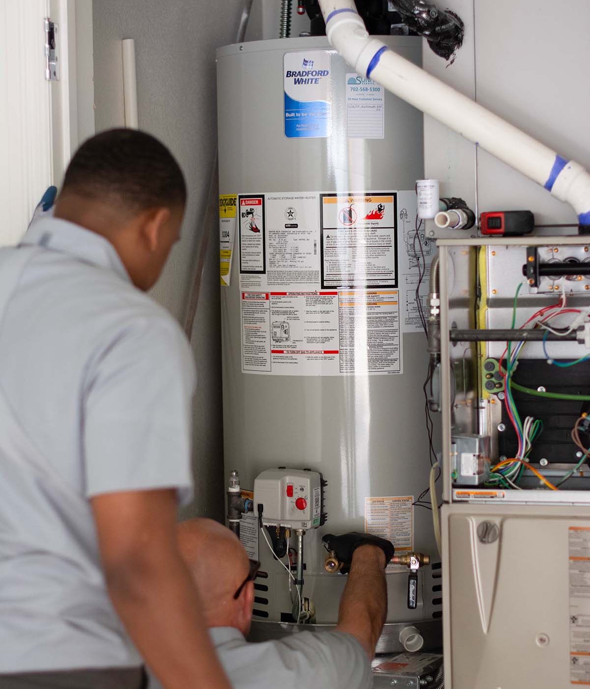 Two sunrise tech installing hear tank