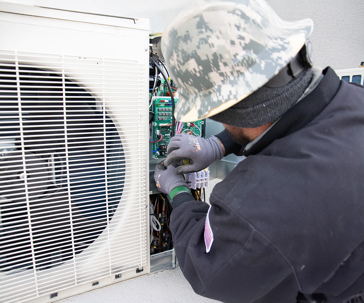 HVAC technician servicing heat pump