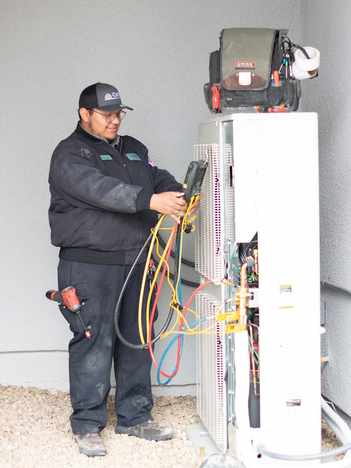 HVAC technician servicing heat pump